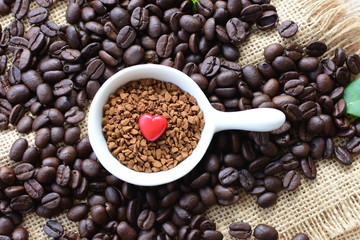Coffee beans, accompanied by processed coffee powder