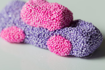 Shiny bubbles slime car shape close up still on a white background