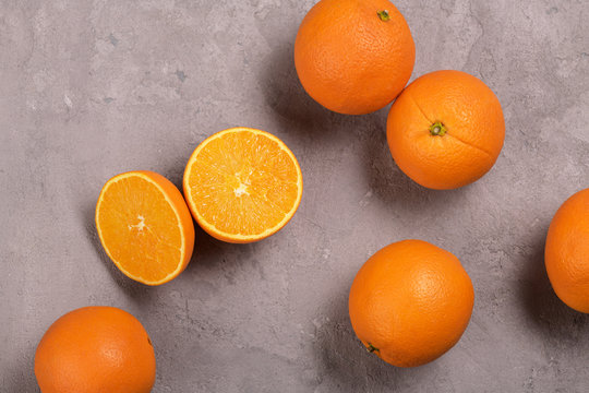 juicy oranges on a gray background © Rustam