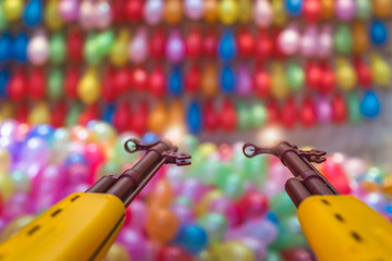 Rubber bullet guns pointed at balloons