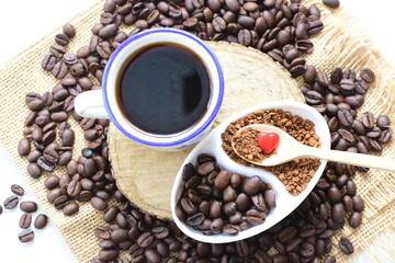 Coffee beans, accompanied by processed coffee powder