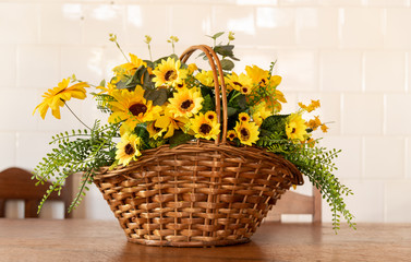 Fototapeta na wymiar Flower arrangement composed of a wicker basket and sunflowers