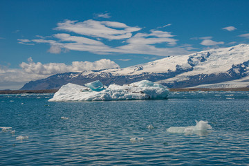 View of Glacier Lagoon Jokulsarlon with icebergs and Vatnajokull Glacier tongue, Iceland, summer