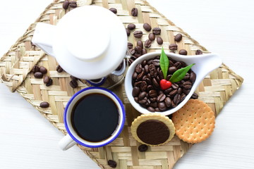 Coffee beans decorated with red heart and green leaves
