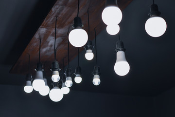 Retro bulb lamps on dark grey grunge background. Selective focus. 