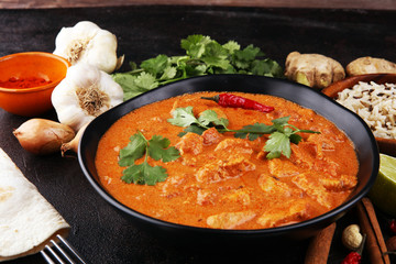 Chicken tikka masala spicy curry meat food in pot with rice and naan bread. indian food