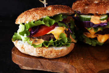 Tasty fresh meat burgers with salad and cheese. Homemade angus burger.