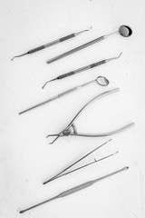 Dental instruments - set with mirrors - on white background top-down pattern