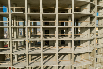 Aerial view of concrete frame of tall apartment building under construction in a city