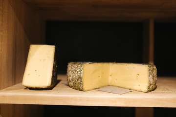 Goat Cheese of wooden board in cheese shop