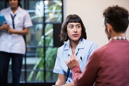 Portrait of Woman in healthcare industry having consultation with patient, East London, Great Britian