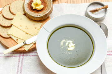 Bowl of spinach soup with a swirl of cream healthy food starter or main meal
