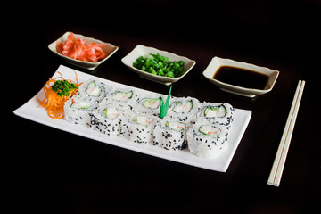 sushi rolls with Soy sauce on a black background