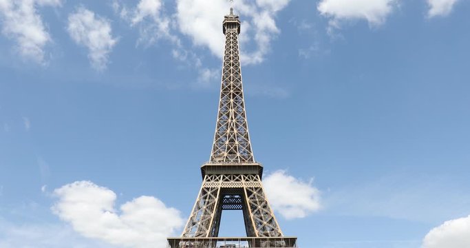 Eiffel Tower in Paris in a sunny summer day, frontal tilt view, blue sky in France