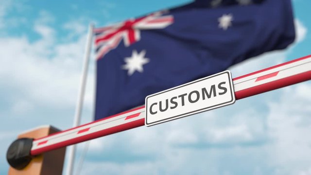 Closed boom gate with CUSTOMS sign on the Australian flag background. Border closure or protective tariffs in Australia