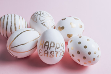 Easter eggs are hand-drawn on pink pastel background. Selective focus. Space for text. Minimalism and Happy Easter concept.