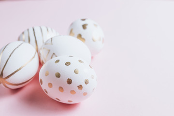 Easter eggs are hand-drawn on pink pastel background. Selective focus. Space for text. Minimalism and Happy Easter concept.