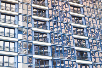 Beautiful modern blue glass fiberglass windows of the facade wall of a modern skyscraper building house. Background, texture