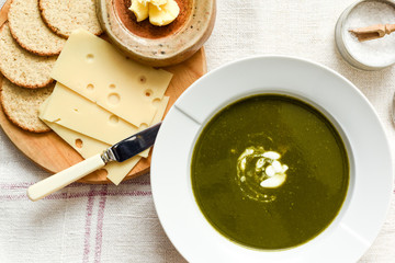 Bowl of spinach soup with a swirl of cream healthy food starter or main meal