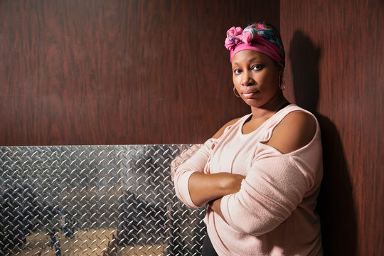 A woman stands with her arms crossed looking at camera., Jacksonville, Florida, USA