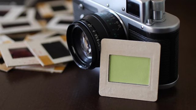 Vintage film camera and slide film with green screen