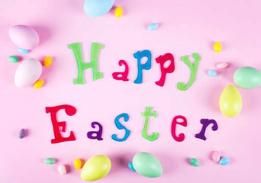 Happy Easter message on a pink background with assorted Easter eggs