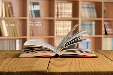 Open book on old wooden table