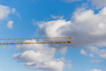 Crane and cloudy sky. Details. White and gray clouds