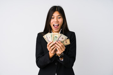 Young chinese business woman holding money isolated