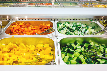 Fresh salad bar with various fresh assortment of ingredients, fruits and proteins. choice of healthy foods for salads