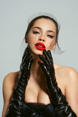 Beautiful blond woman, sexy model with red lips, dressed in black lingerie outfit body corset and...