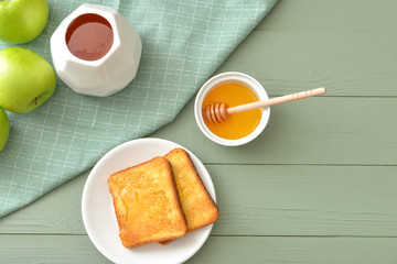 Sweet honey, apples and toasted bread on table