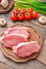 Raw pork meat on wooden background