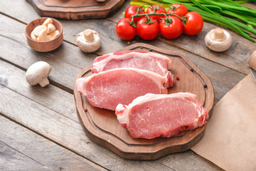 Raw pork meat on wooden background