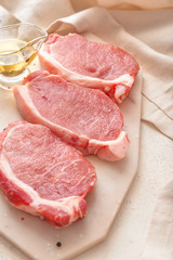 Raw pork meat with oil on table