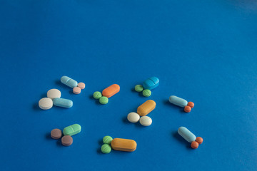 Pills and tablets forming small penises and testicles. Concept of masculinity, male dominance and...