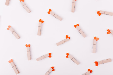 Beautiful greeting card or background design of Pink Hearts pinned with a clothes peg. White background. Copy Space for Texts