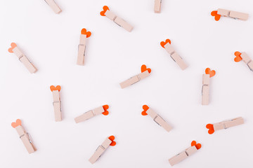 Beautiful greeting card or background design of Pink Hearts pinned with a clothes peg. White background. Copy Space for Texts