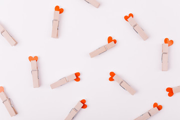 Beautiful greeting card or background design of Pink Hearts pinned with a clothes peg. White background. Copy Space for Texts