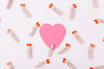 Beautiful greeting card or background design of Pink Hearts pinned with a clothes peg. White background. Copy Space for Texts
