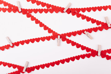 A beautiful mosaic made from a multitude of bright red heart strings interlaced criss-crossed and interwoven with clothes pegs. Background, Gift Card