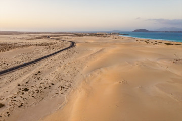 High angle view of road going through Corralejo dunes nature park in Fuerteventura. Aerial drone shot in october 2019