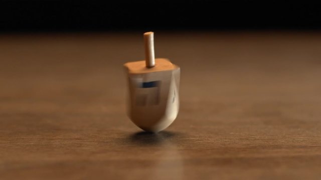 Hanukkah wooden dreidel spinning, slow motion, BMPCC 4K