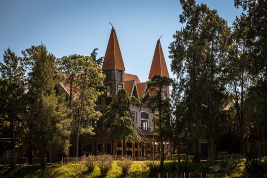 GONZALEZ CATAN, ARGENTINA, SEPTEMBER 28, 2019: Abandoned buildings in the amazing medieval town of Campanopolis, surrounded by forest.
