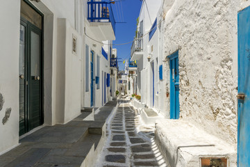 Mykonos town white washed houses and cobblestone street.