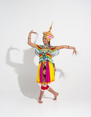 Young lady wearing Thai Tradition southern costume and headdress on her head,showing basic pattern folk dance,black shadow reflection on white background