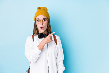 Young student woman isolated pointing to the side