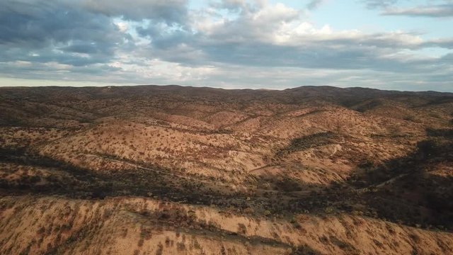 4K aerial drone summer day video African savanna and dry riverbeds surrounded by bush covered hills in Daan Viljoen National Game Park in Khomas Hochland area near Windhoek, Namibia's capital, Africa