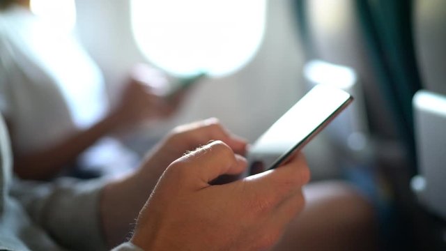 Travel app, Online banking or other smart phone app. Lifestyle. Easy pay using mobile phone or digital device. Communication app or shopping online or working while sitting in plane business travel