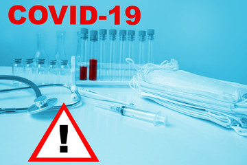medical laboratory test tube with blood inside, stethoscope, syringe, protective masks, concept of...